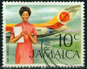 Colnect-518-848-Air-Jamaica-flight-attendant-before-the-aircraft-fuselage.jpg