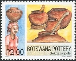 Colnect-1424-462-Finished-Sekgatla-Pots-and-Woman-Carrying-Water-in-a-Pot.jpg