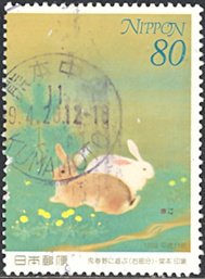 Colnect-2302-242-Rabbits-Playing-in-the-Field-in-Spring.jpg