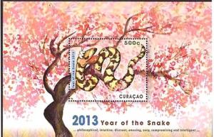 Colnect-2603-478-Snake-and-tree-with-blossom.jpg