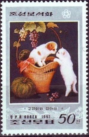 Colnect-2500-166-Puppy-in-basket-touching-noses-with-kitten.jpg