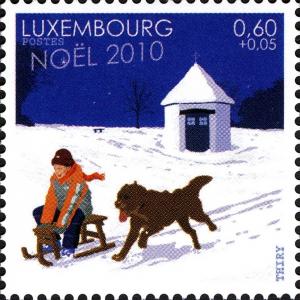 Colnect-1018-859-Child-with-Dog-Canis-lupus-familiaris-while-sledding.jpg