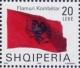 Colnect-1533-617-Albanian-flag-blowing-in-wind.jpg