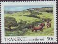 Colnect-1713-614-Cattle-grazing-on-verdant-plain.jpg