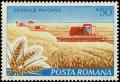 Colnect-5120-738-Wheat-farm-and-combine-harvester.jpg