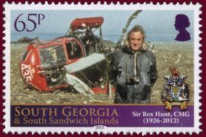 Colnect-1757-367-Rex-Hunt-standing-in-front-of-wrecked-naval-Wasp-helicopter.jpg