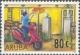 Colnect-982-074-Mailman-on-motor-scooter-placing-mail-in-mailbox.jpg