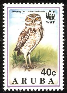 Colnect-579-869-WWF-Burrowing-owl-Adult-with-prey.jpg