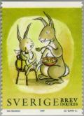 Colnect-164-949-Rabbit-feeding-baby-rabbit.jpg