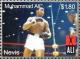 Colnect-5206-393-Muhammed-Ali-in-ring-with-fists-raised-opponent-at-right.jpg