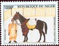 Colnect-5147-629-Man-saddled-horse.jpg