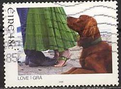 Colnect-1236-596-Dog-at-the-Feet-of-a-Love-Couple.jpg