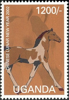 Colnect-2004-931-Dark-brown-and-gray-brown-horse-facing-right-with-and-feet-o.jpg