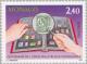 Colnect-149-655-Stamp-album-hands-with-magnifying-glass-and-tweezers.jpg