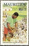 Colnect-2149-323-Dehusking-of-Coconuts.jpg