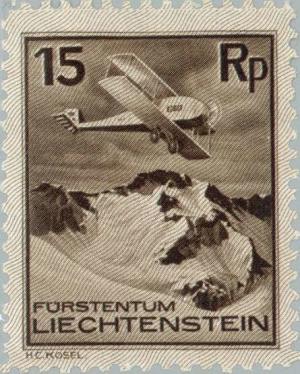 Colnect-131-696-Airplane-over-Snow-capped-Mountain-Peaks.jpg